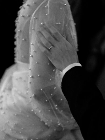 groom touching brides shoulder